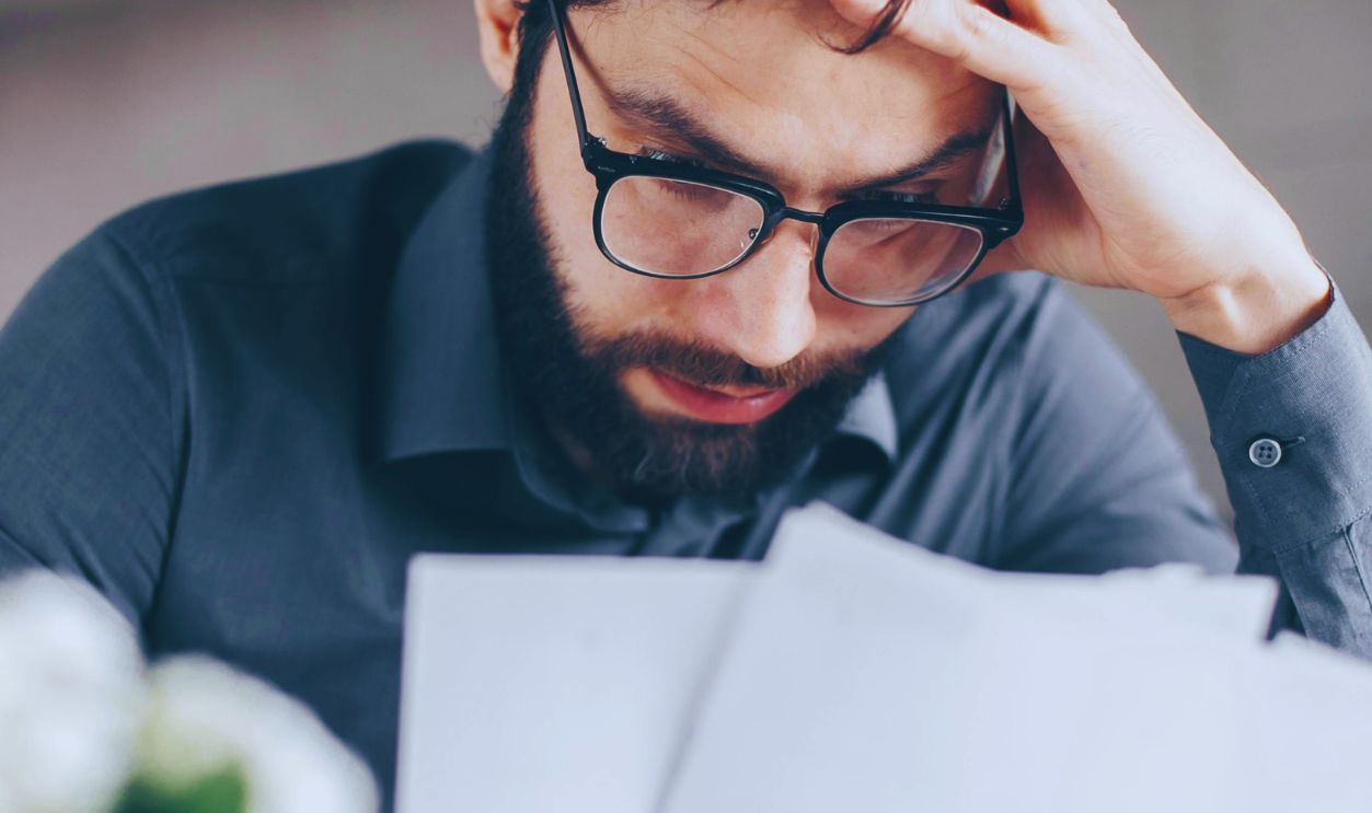 Man in Black Long Sleeve Shirt Holding White Papers