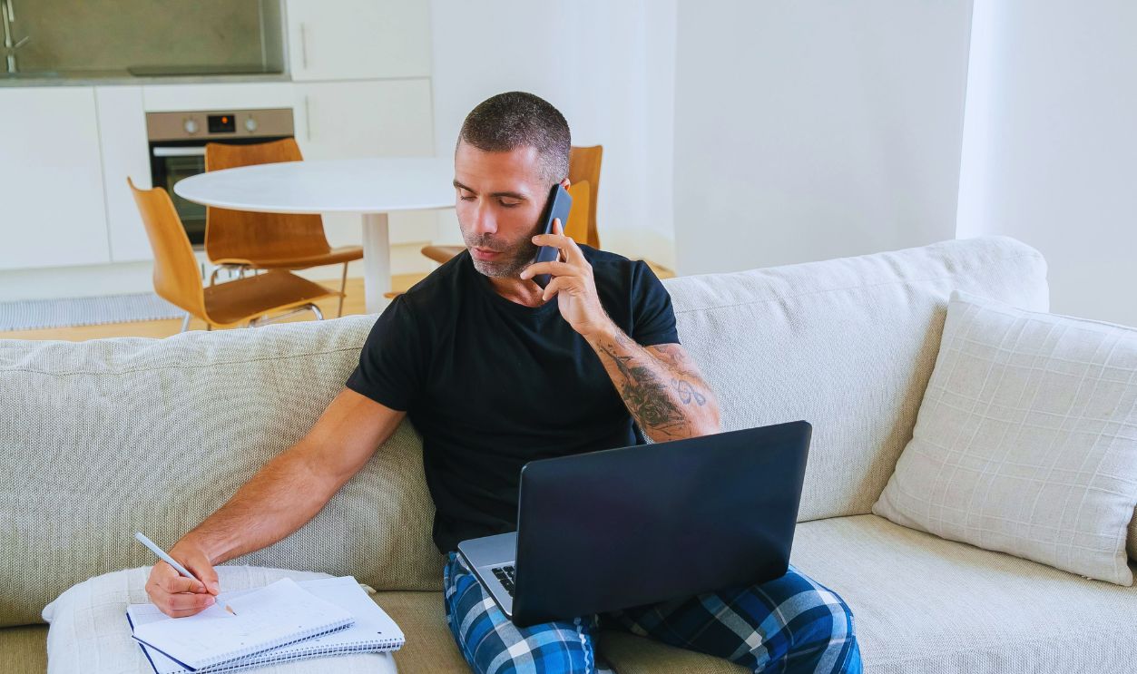 A Man Taking Notes While on a Phone Call