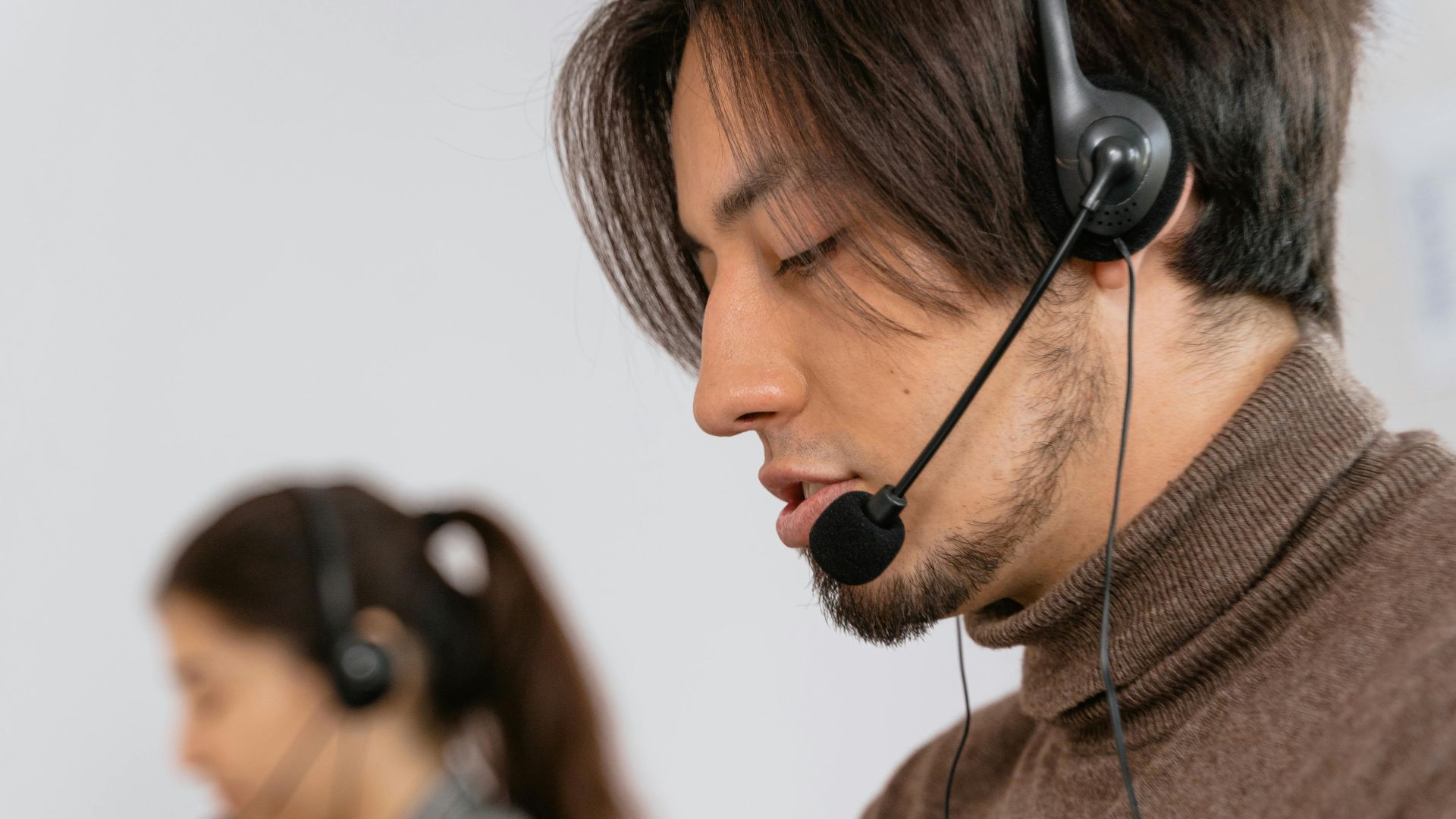 Focused call center employees wearing headsets, assisting customers with exceptional service.