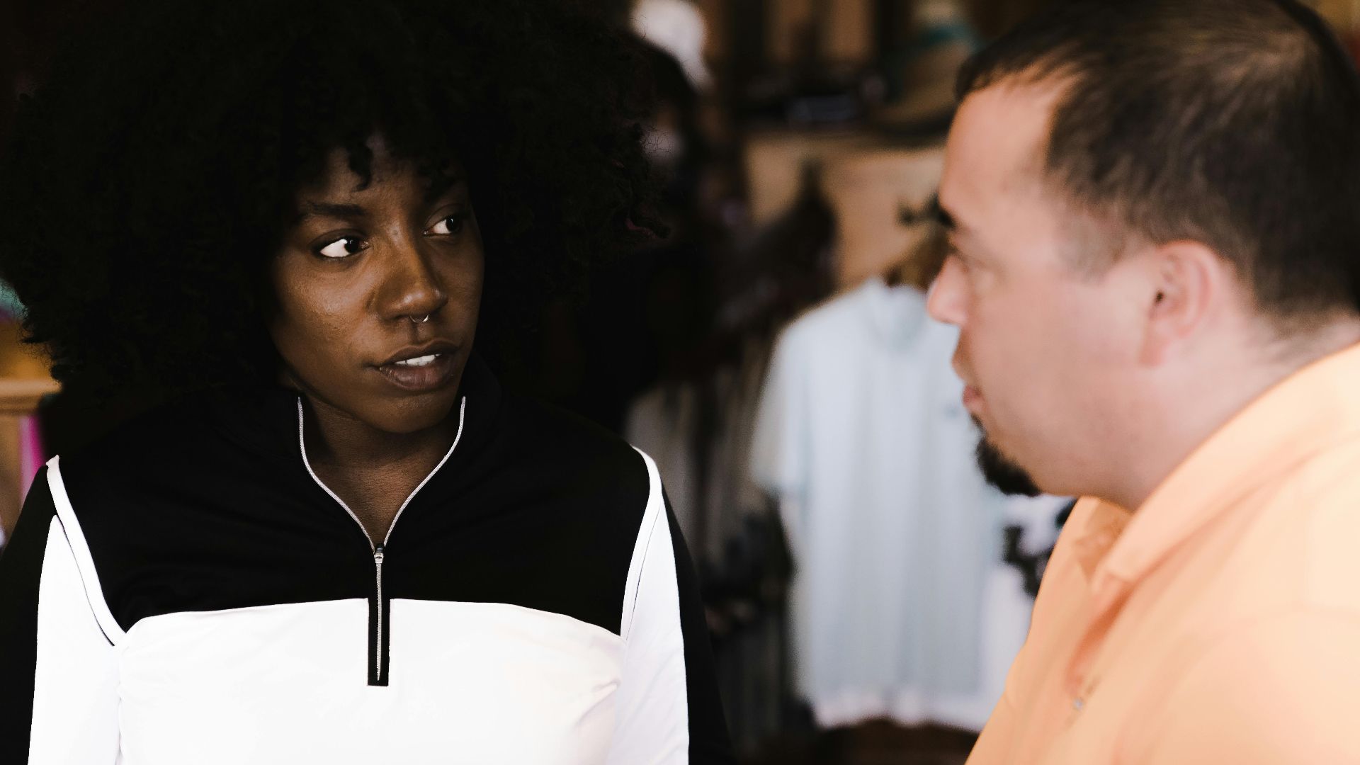 African American woman and man discussing products in a store.