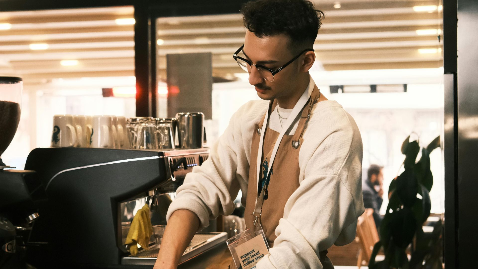 Barista preparing espresso in modern Konya café, showcasing coffee craft and equipment.