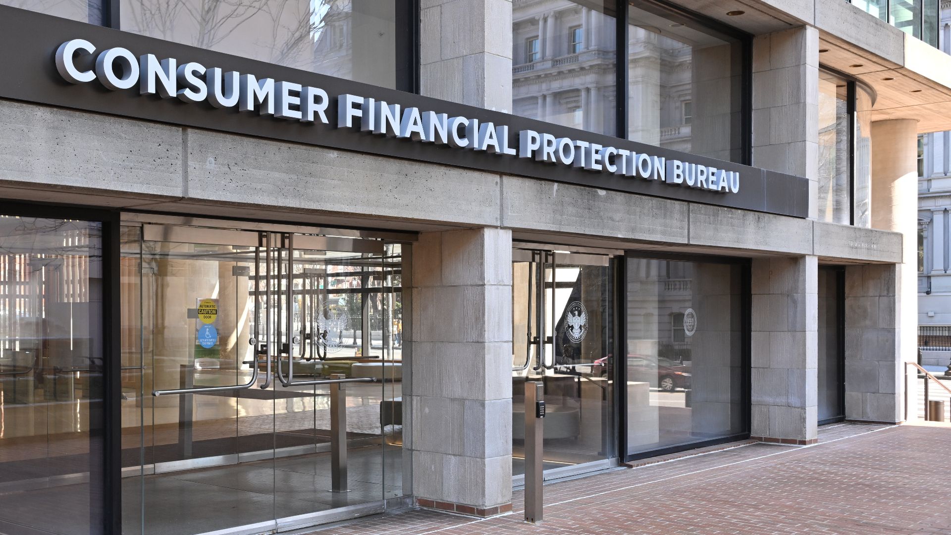 The entrance to the Consumer Financial Protection Bureau headquarters with the bureau's name above it. 1700 G Street NW, Washington, DC 20552.