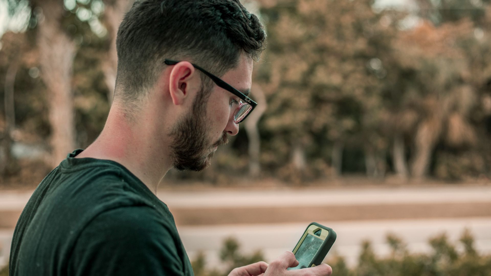 man looking down on his phone
