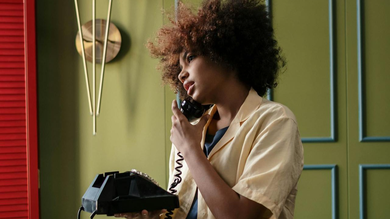 Portrait Photo of Woman in yellow shirt Holding a Telephone