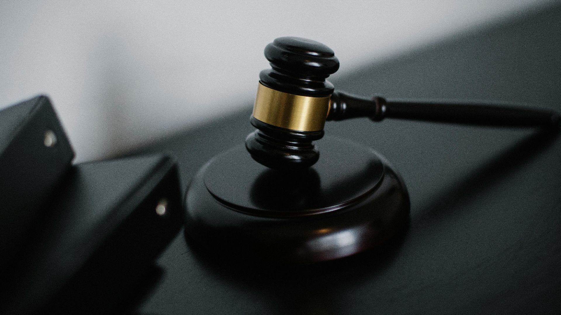 Close-up of a wooden gavel on a desk, symbolizing justice and legal authority.