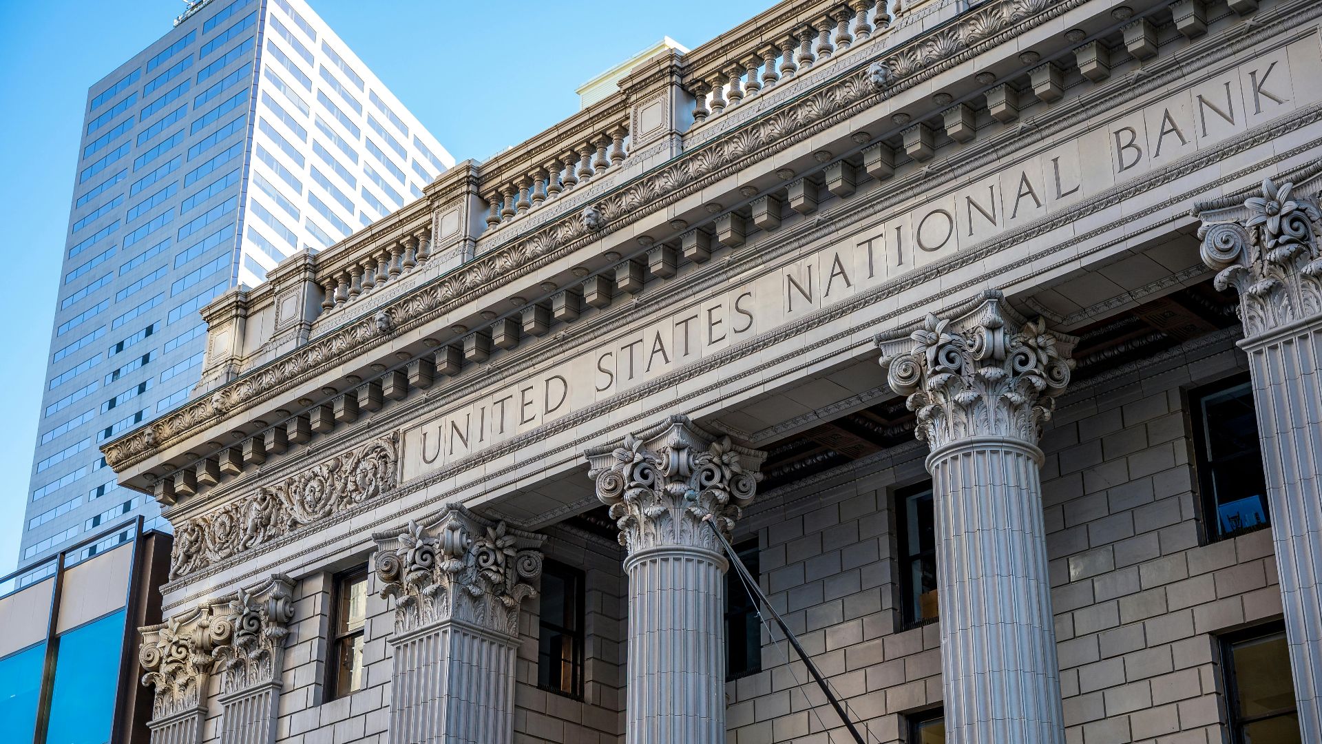 Close view of the United States National Bank building with classic columns and architecture.