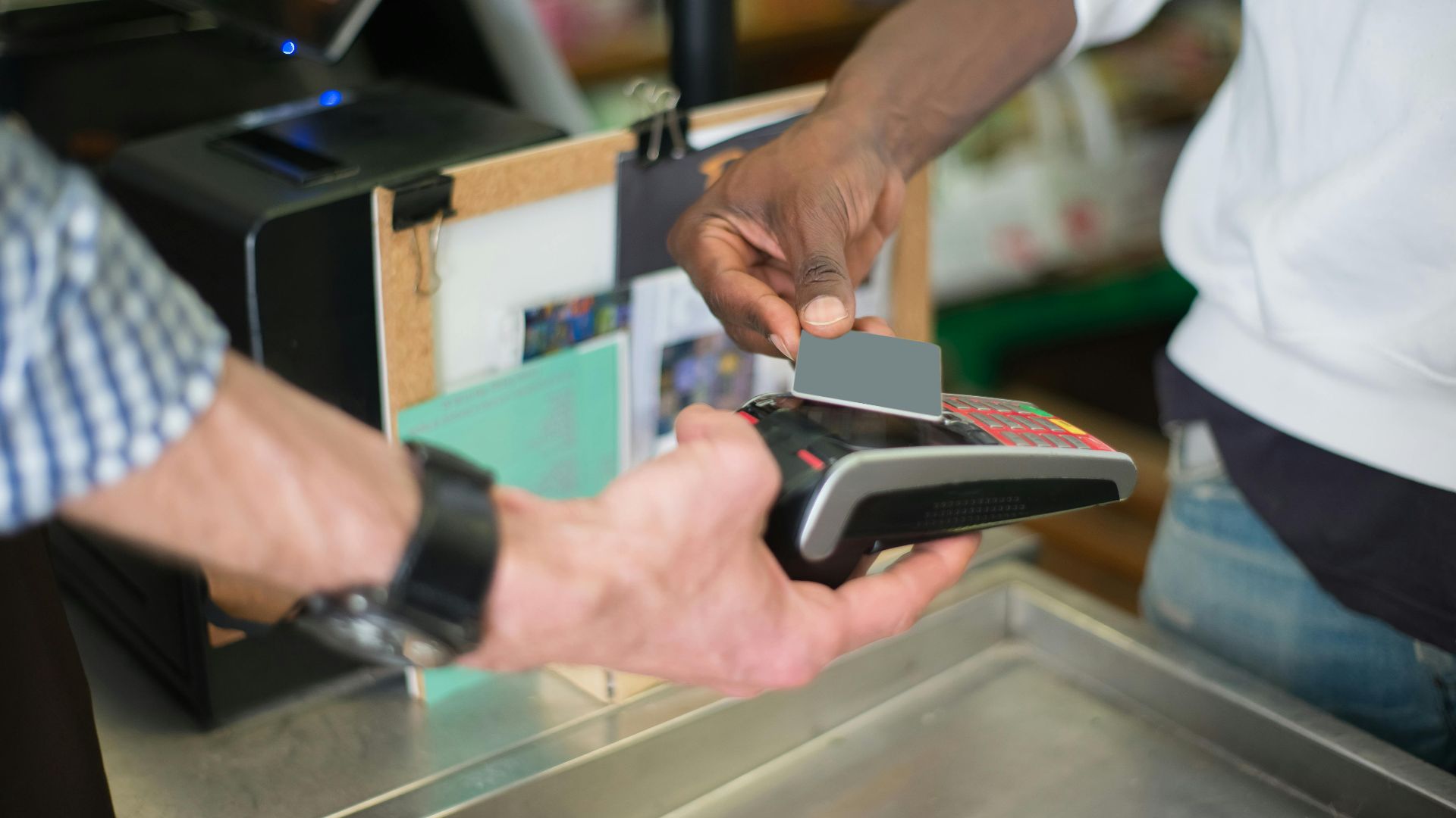 A contactless payment being made using a card reader at a retail store checkout counter.
