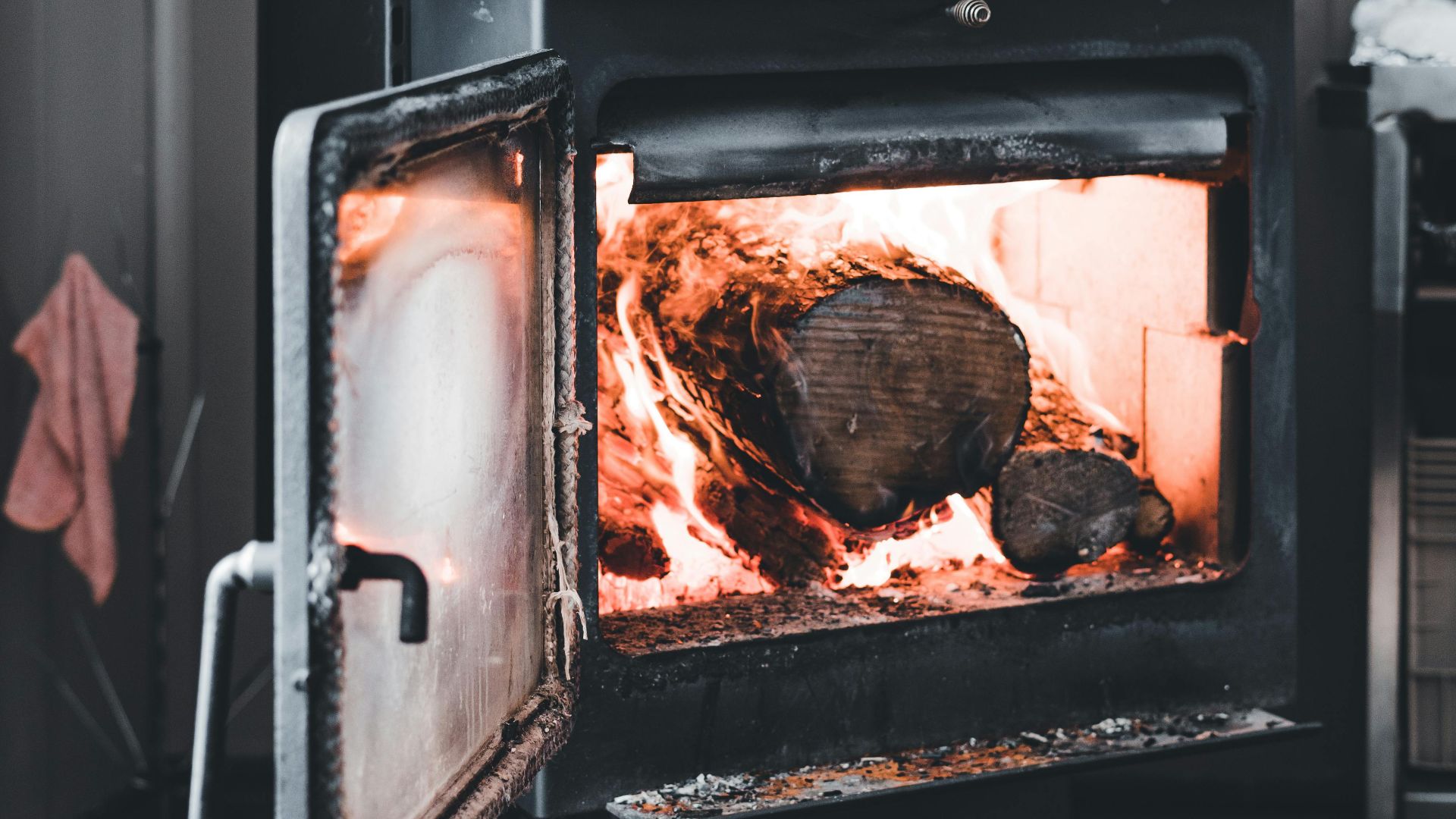 A warm wood-burning stove adds a cozy touch to an indoor space, perfect for cold seasons.