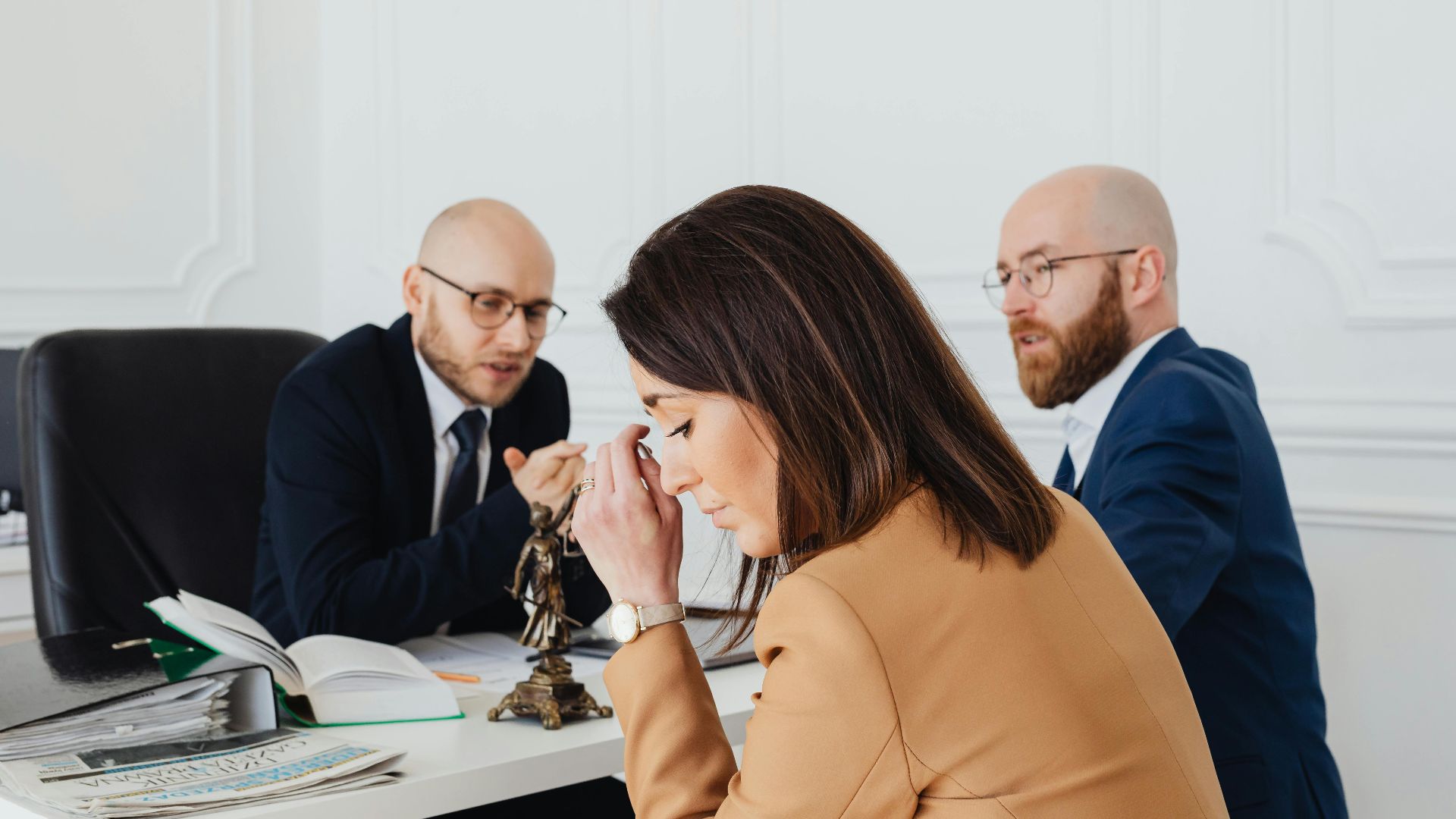 A tense discussion among lawyers and a client in an office setting.