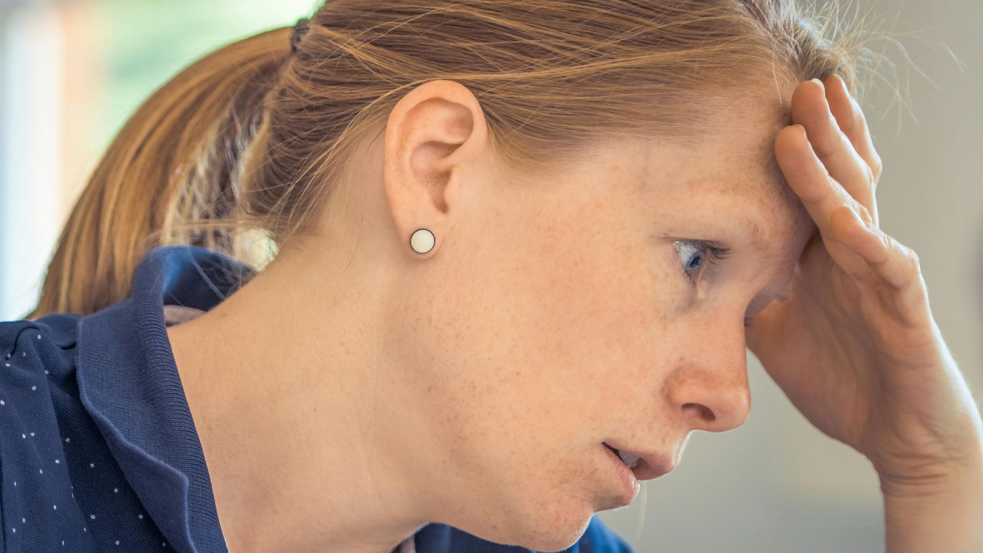 Businesswoman showing stress and concentration while working at her desk.