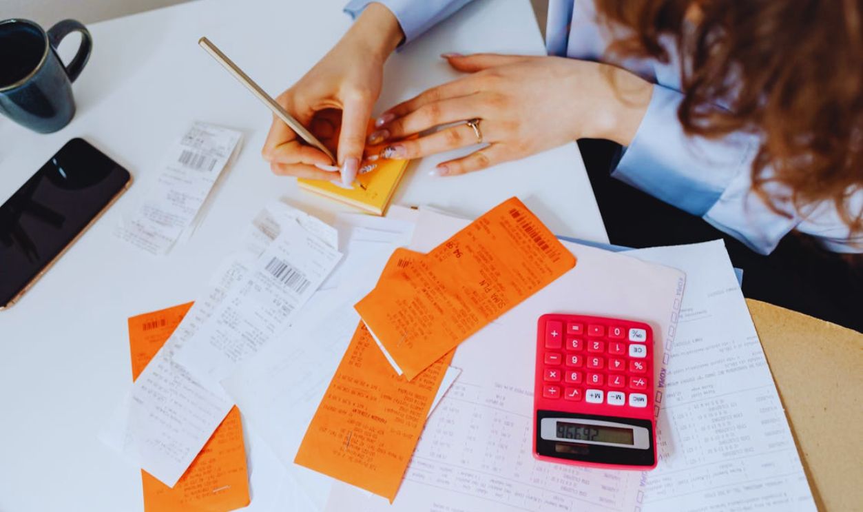 Person Writing on a Sticky Note