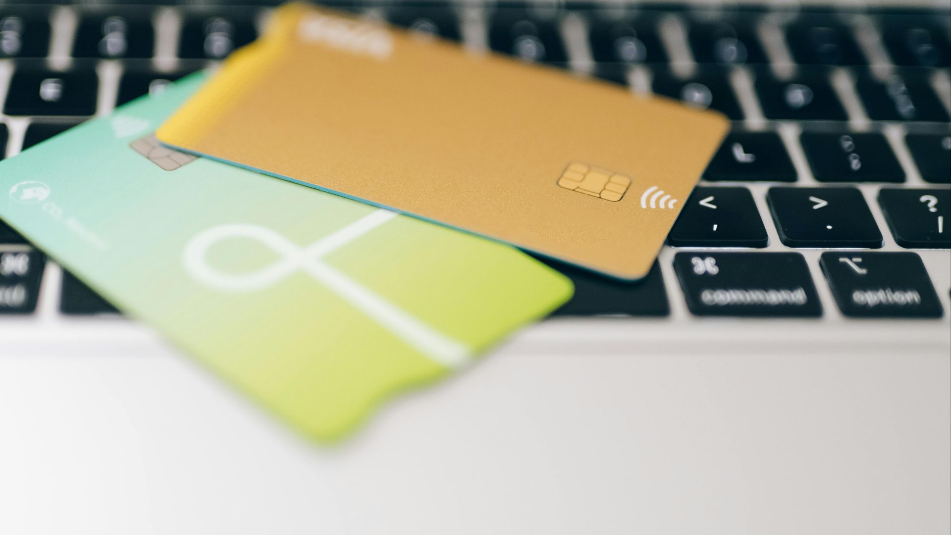 Two credit cards placed on a laptop keyboard highlighting online payment concept.