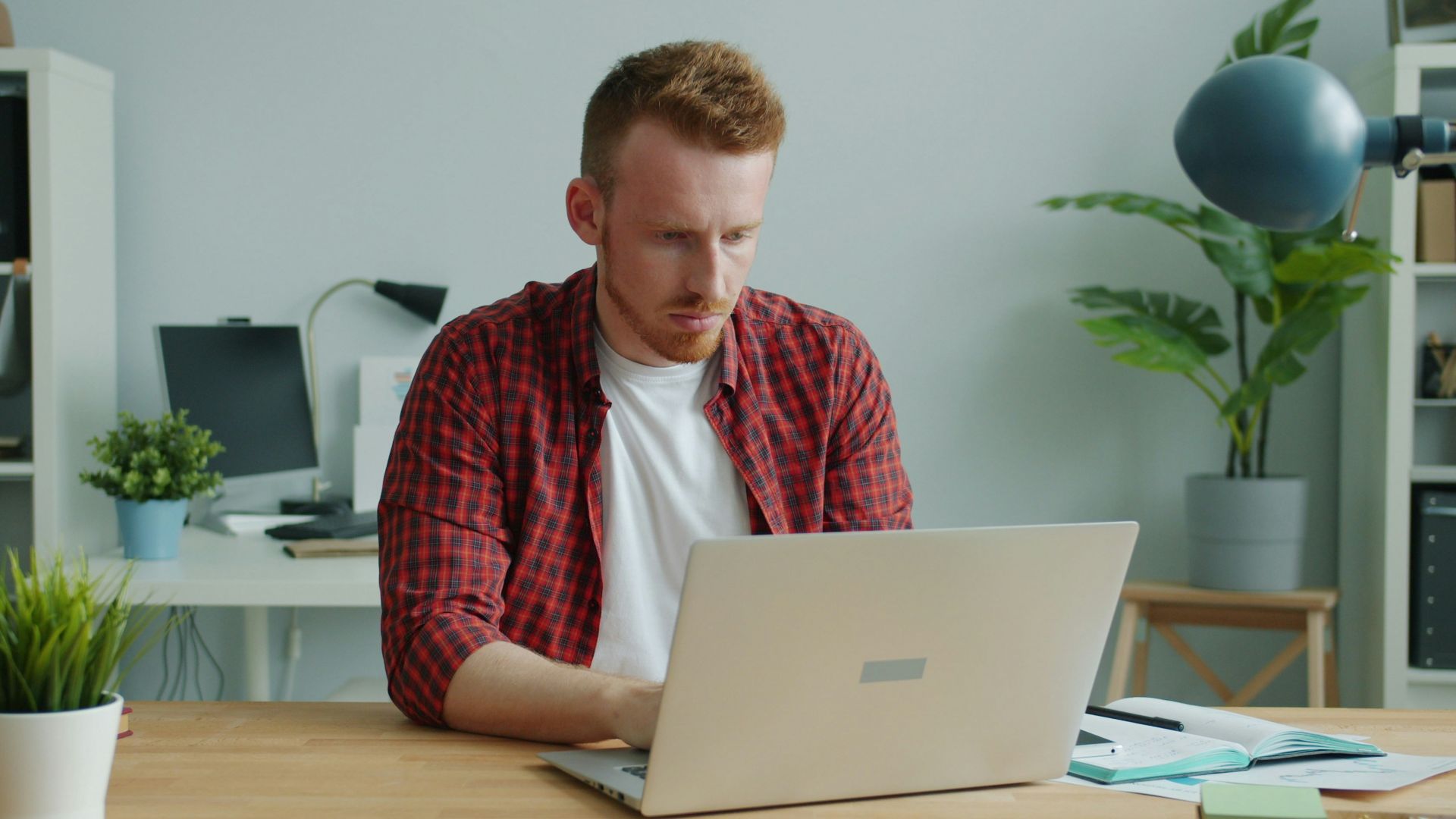 Man working on a laptop at a desk.