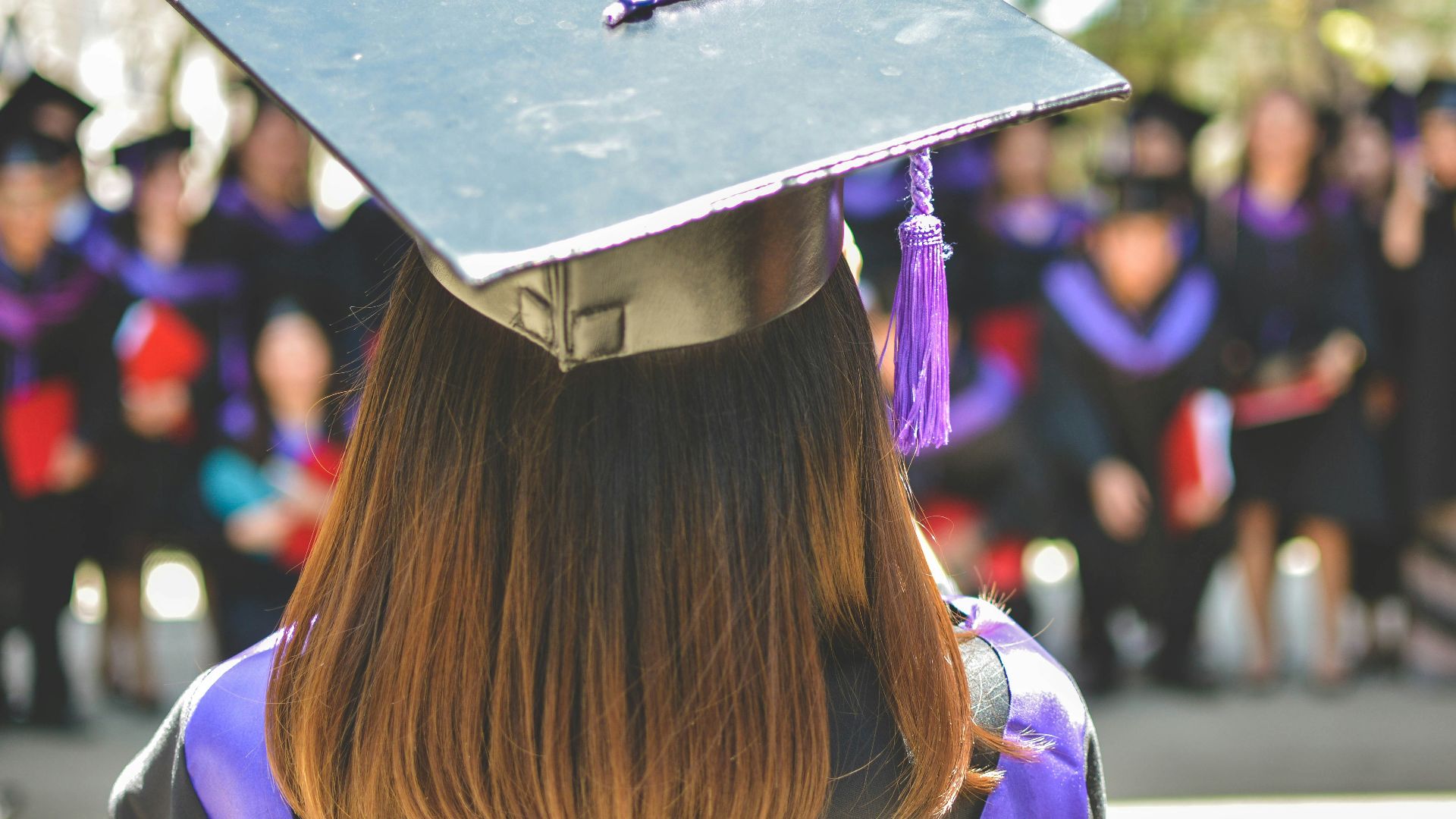 woman wearing academic cap and dress selective focus photography