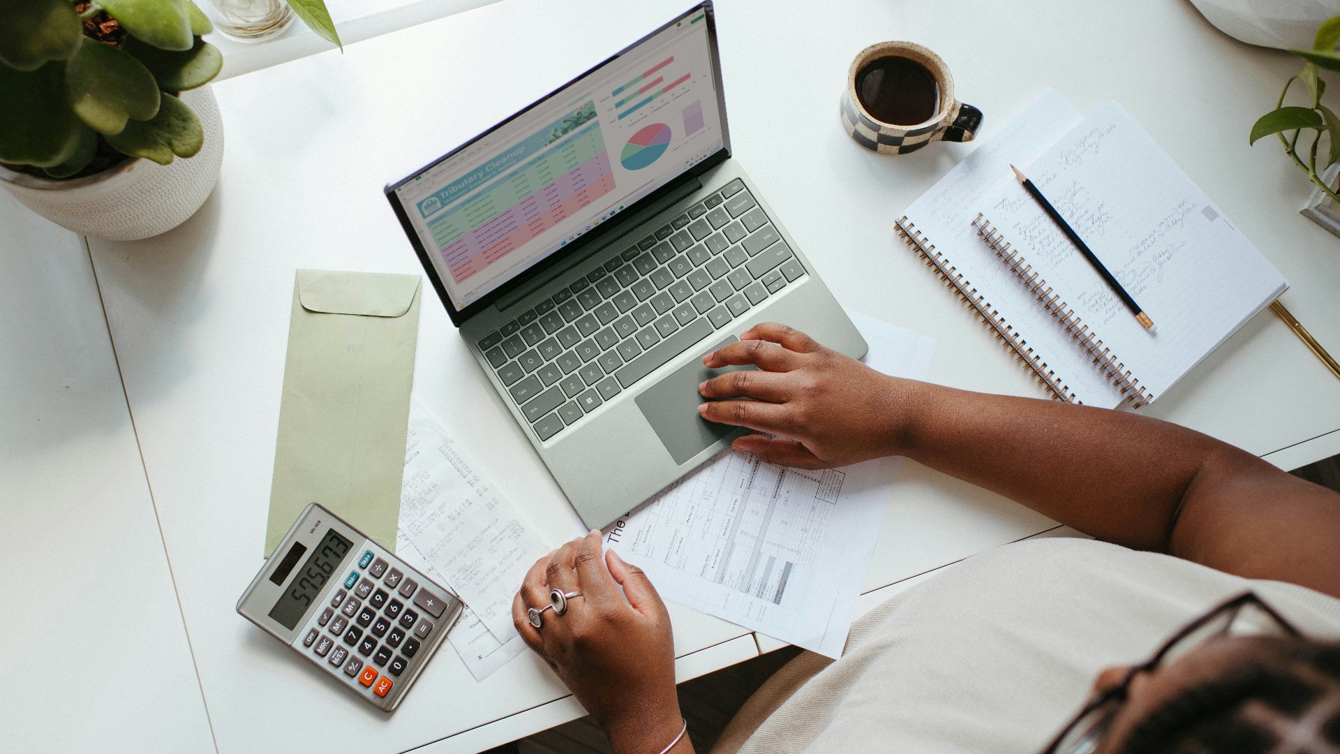 a person sitting at a table with a laptop