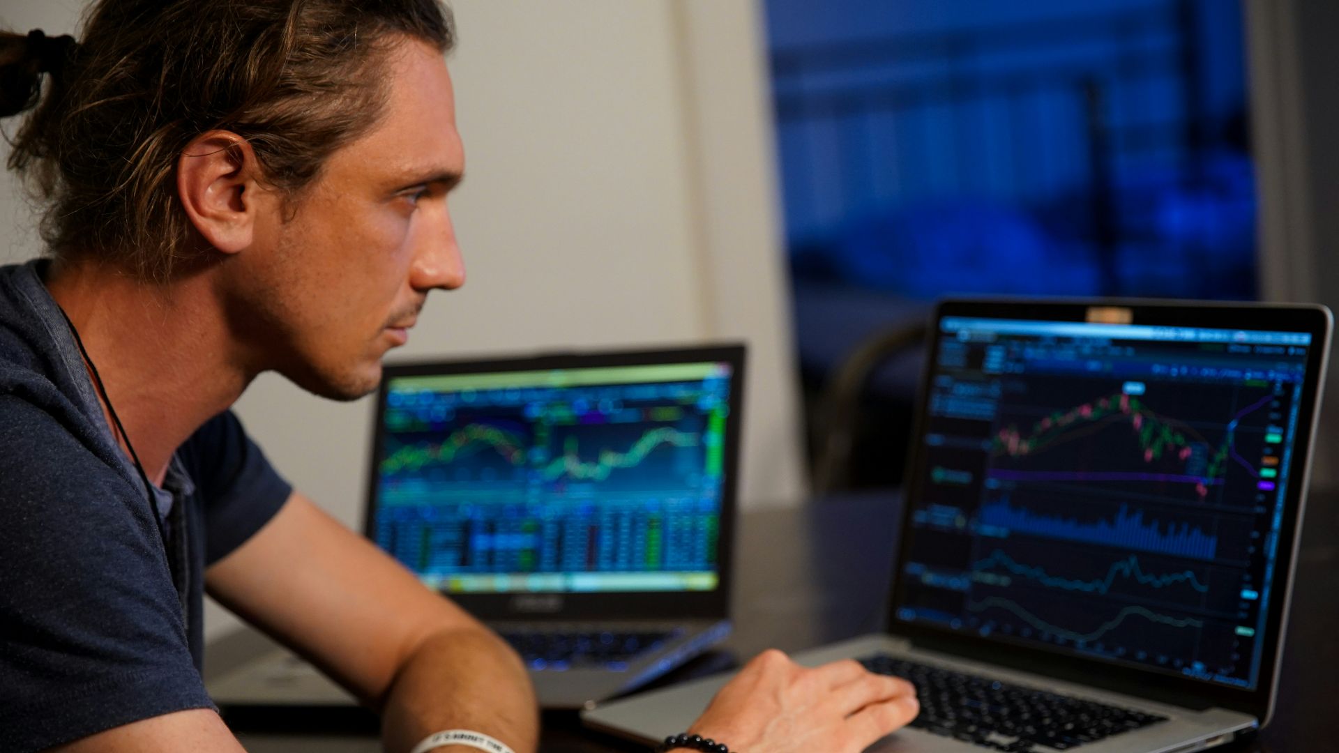 man sitting in front of the MacBook Pro