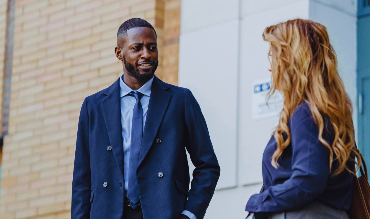 Two People Standing in a City