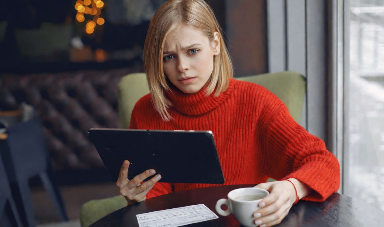 Woman in Red Sweater Holding Tablet Computer