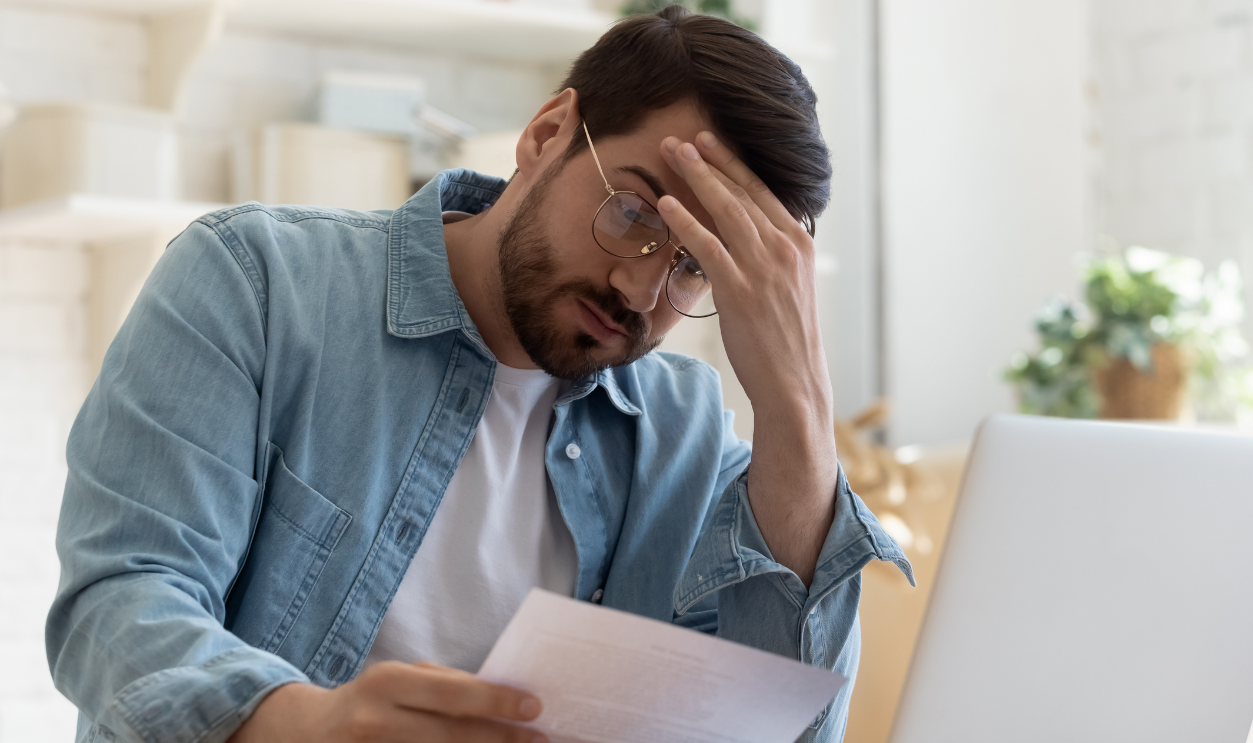 Upset frustrated young man reading bad news