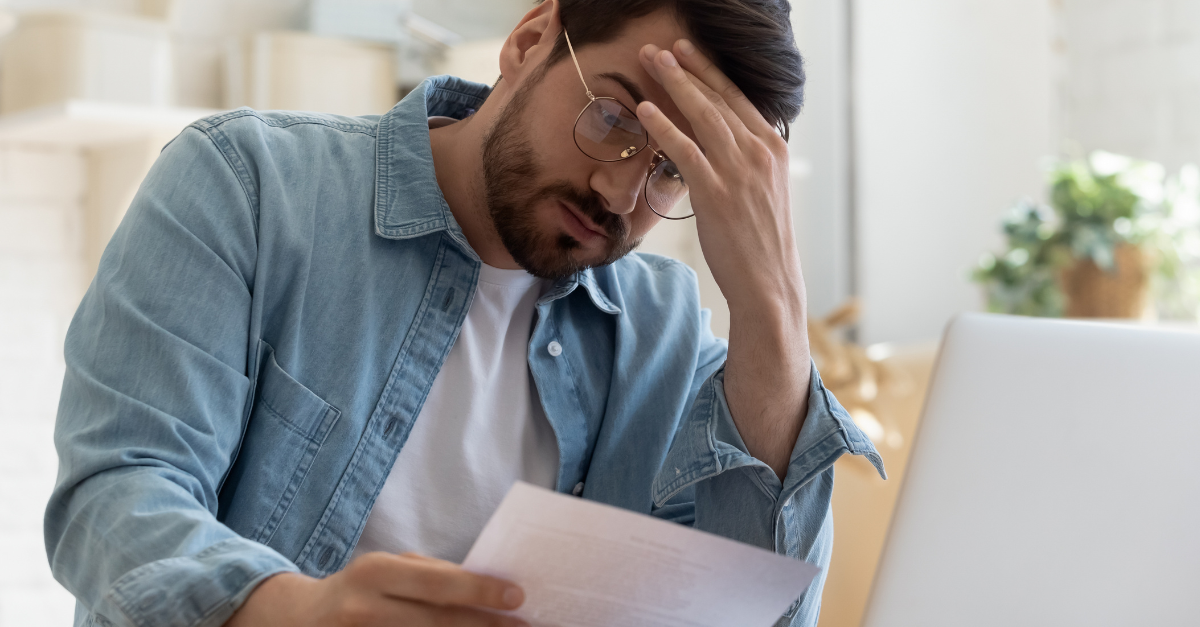 Upset frustrated young man reading bad news