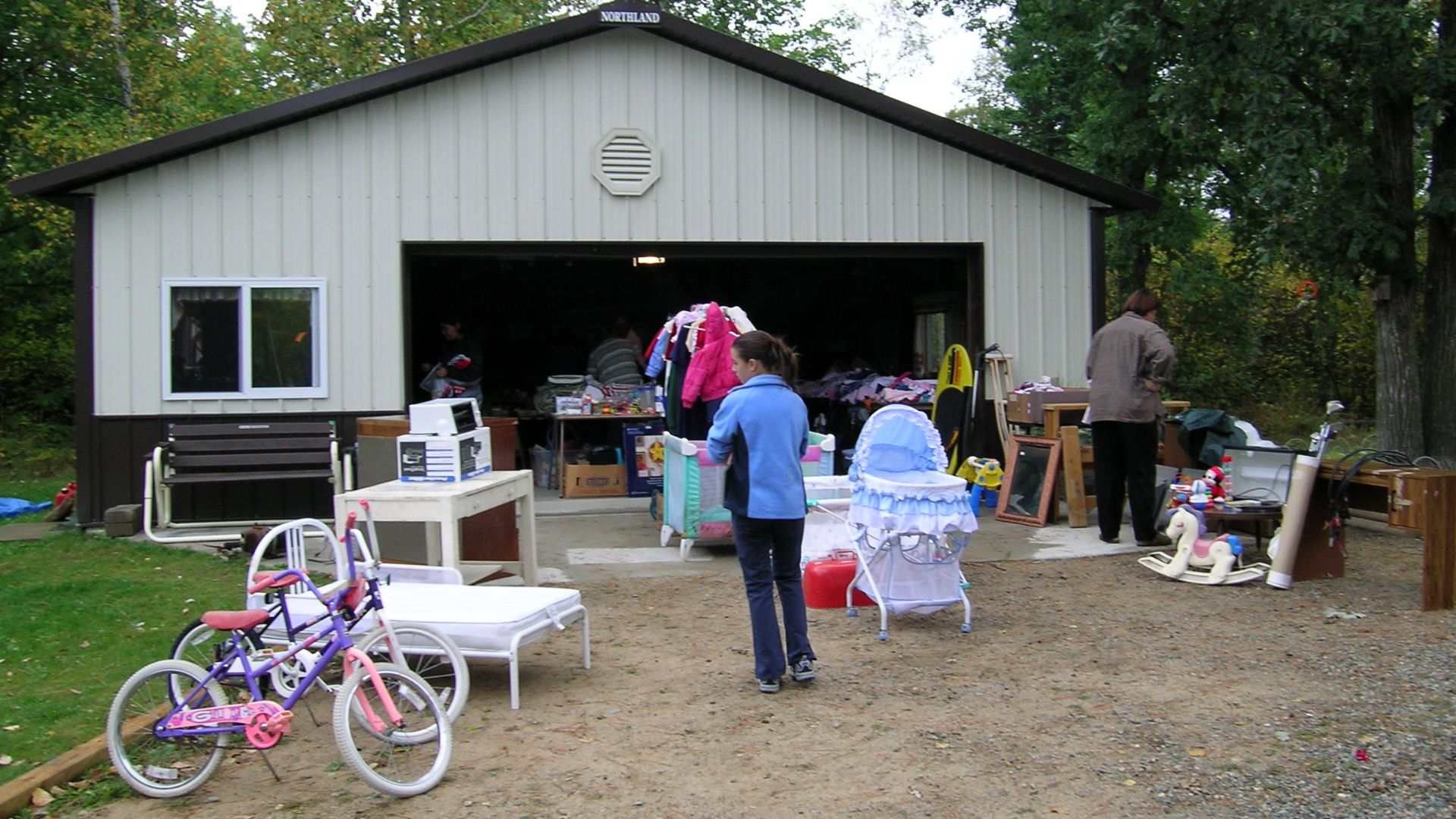 Scope and content:  The original finding aid described this photograph as:
Original Caption: Shoppers hunt for bargains at a garage sale.
Location: Minnesota (47.840° N 93.641° W)

Status: Public domain. Photo by S. Clyde