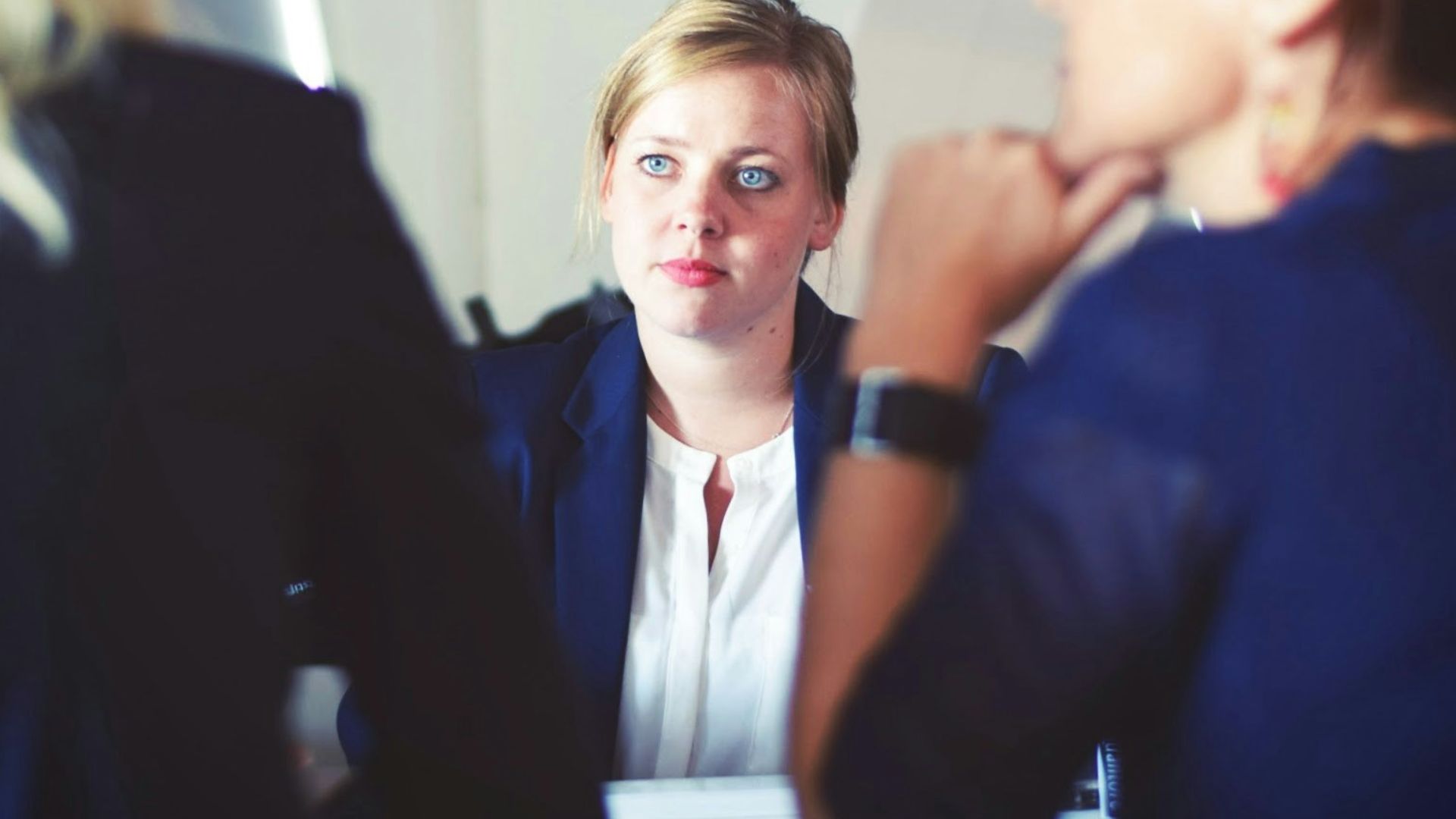 three women sitting beside table