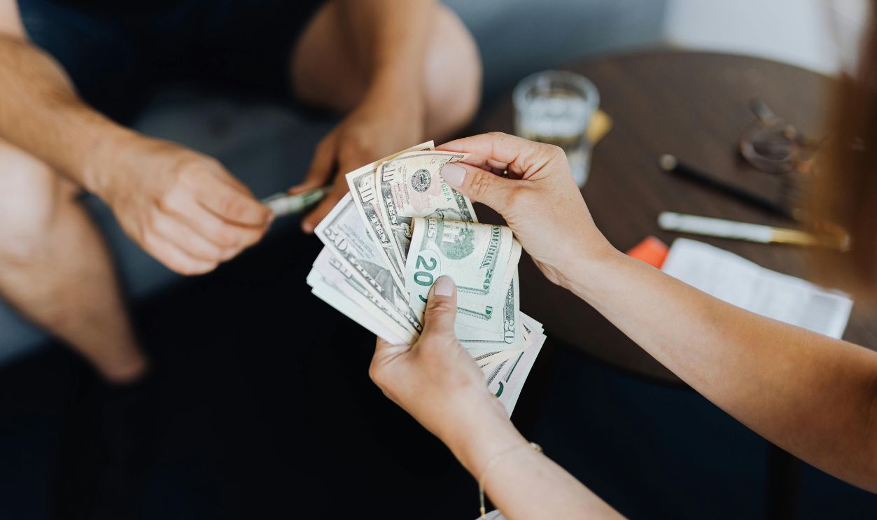 Person Counting Dollar Bills