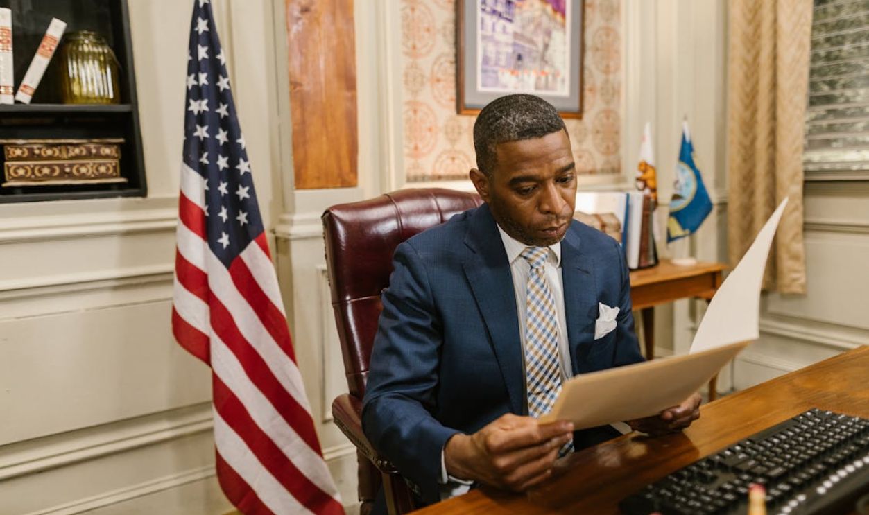A Man in Suit while Reading a Document
