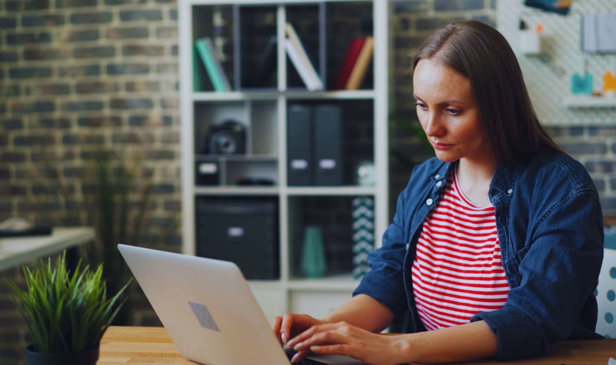 Worried Woman Writing on Laptop at in Office