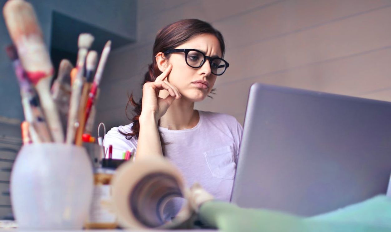 Woman in White Crew Neck Shirt Wearing Black Framed Eyeglasses