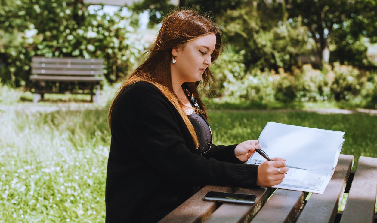 Woman correcting information in paper with pen