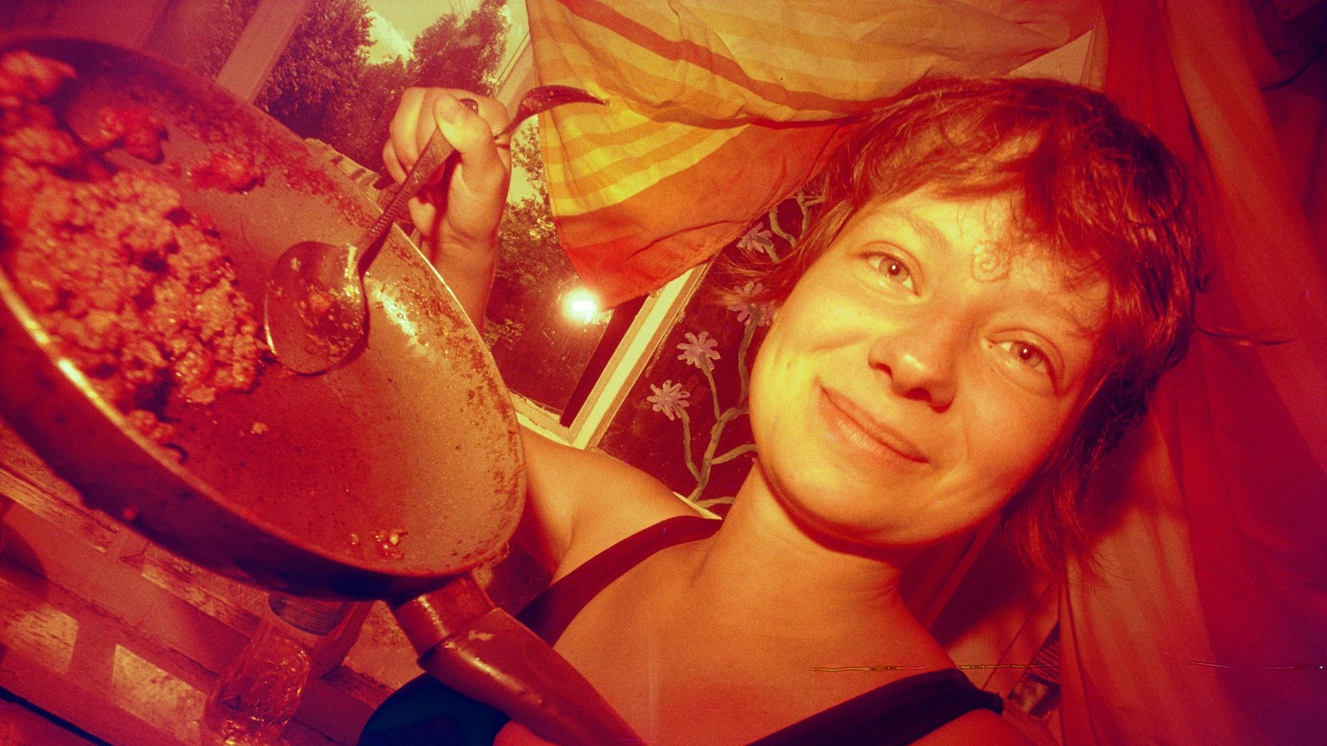 a woman holding a pan with food in it