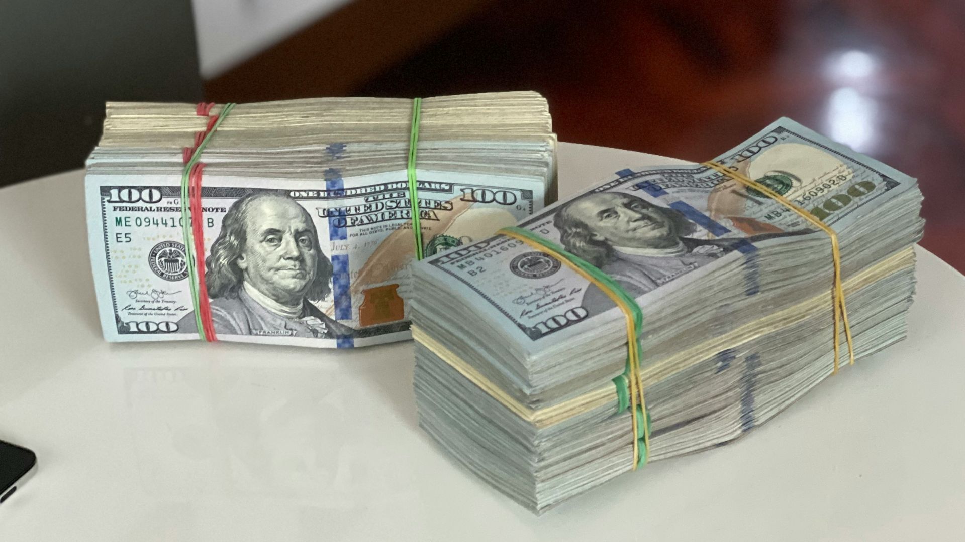 a stack of money sitting on top of a white table