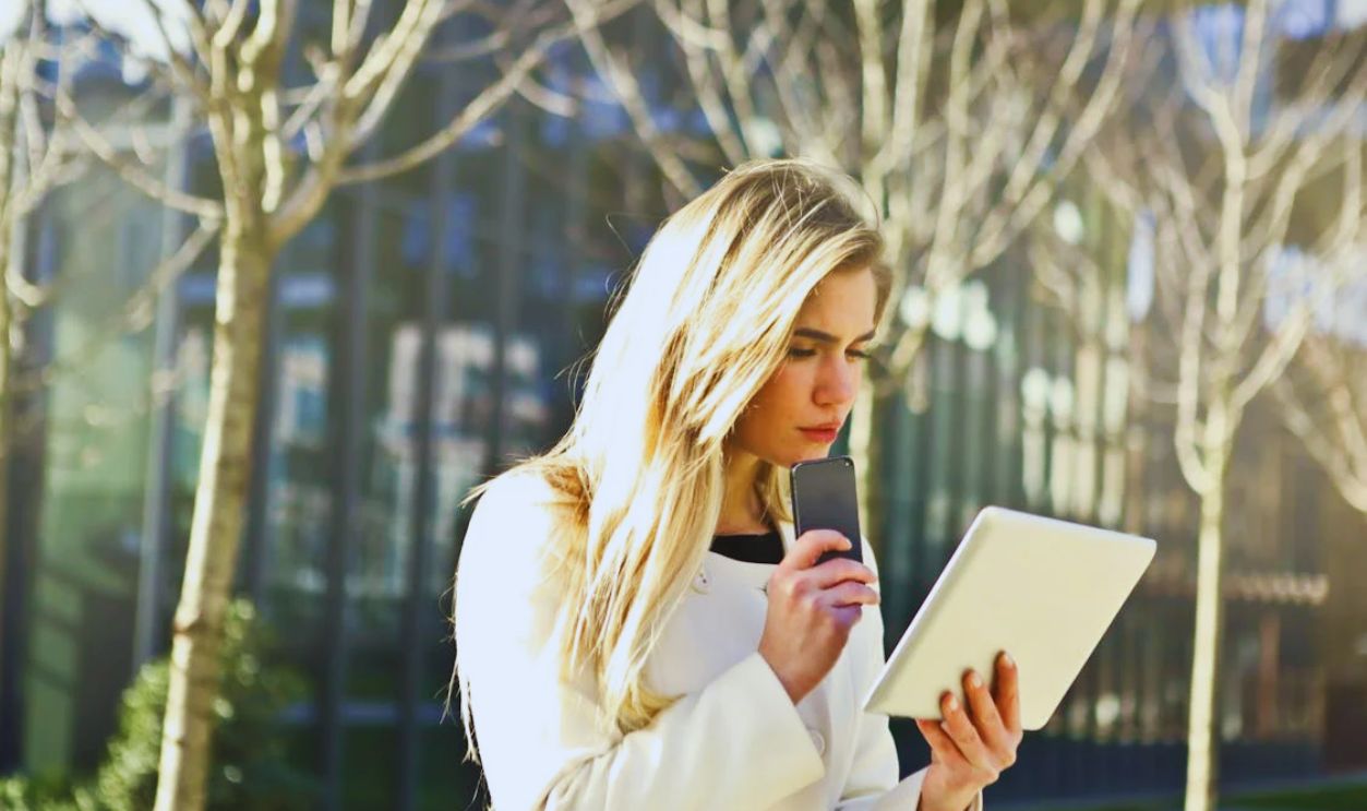 Brown-haired Woman Holding a White Wireless Device