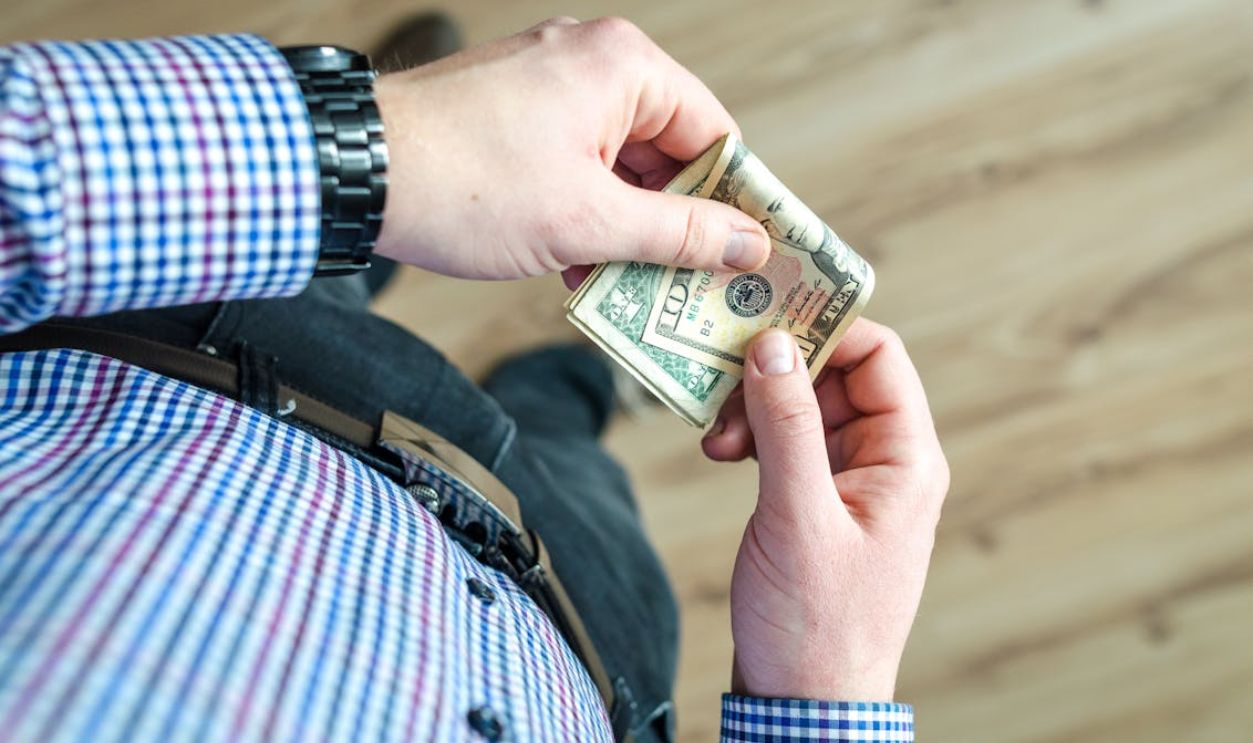 Person Holding 100 Us Dollar Banknote