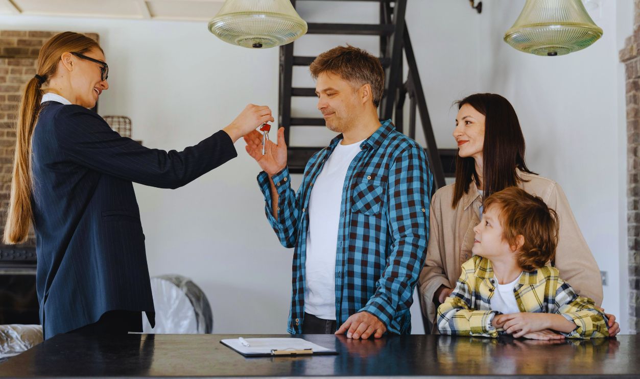 A Female Realtor Handing Over the Key