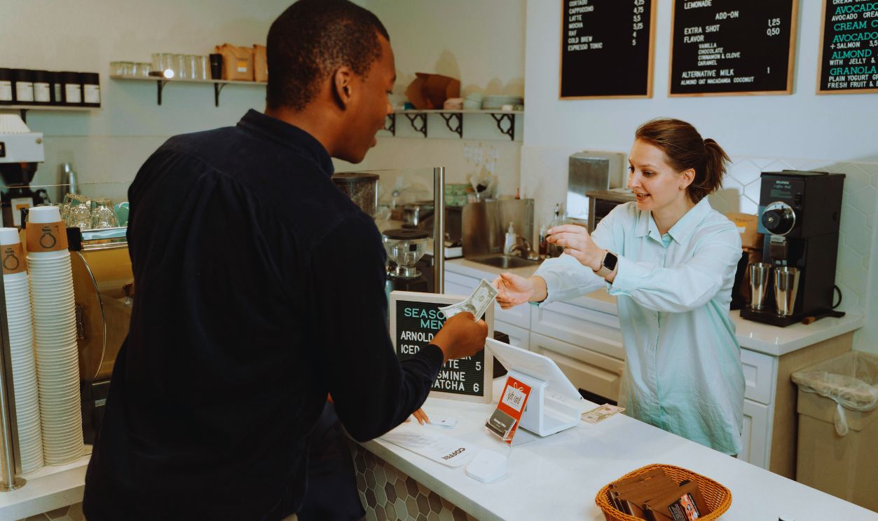 A Woman Receiving Money from the Customer