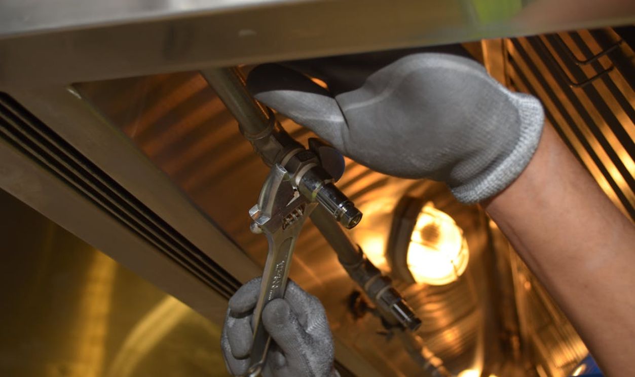 Close-up of Man Using a Spanner