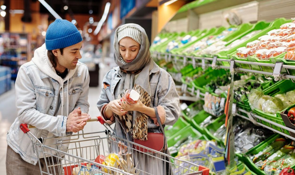Couple with a Shopping Cart Buying Groceries