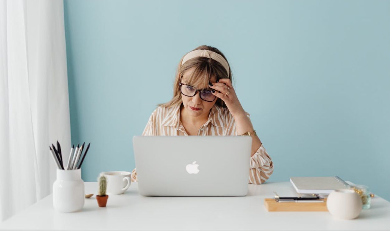 A Woman Sitting in front of a Laptop