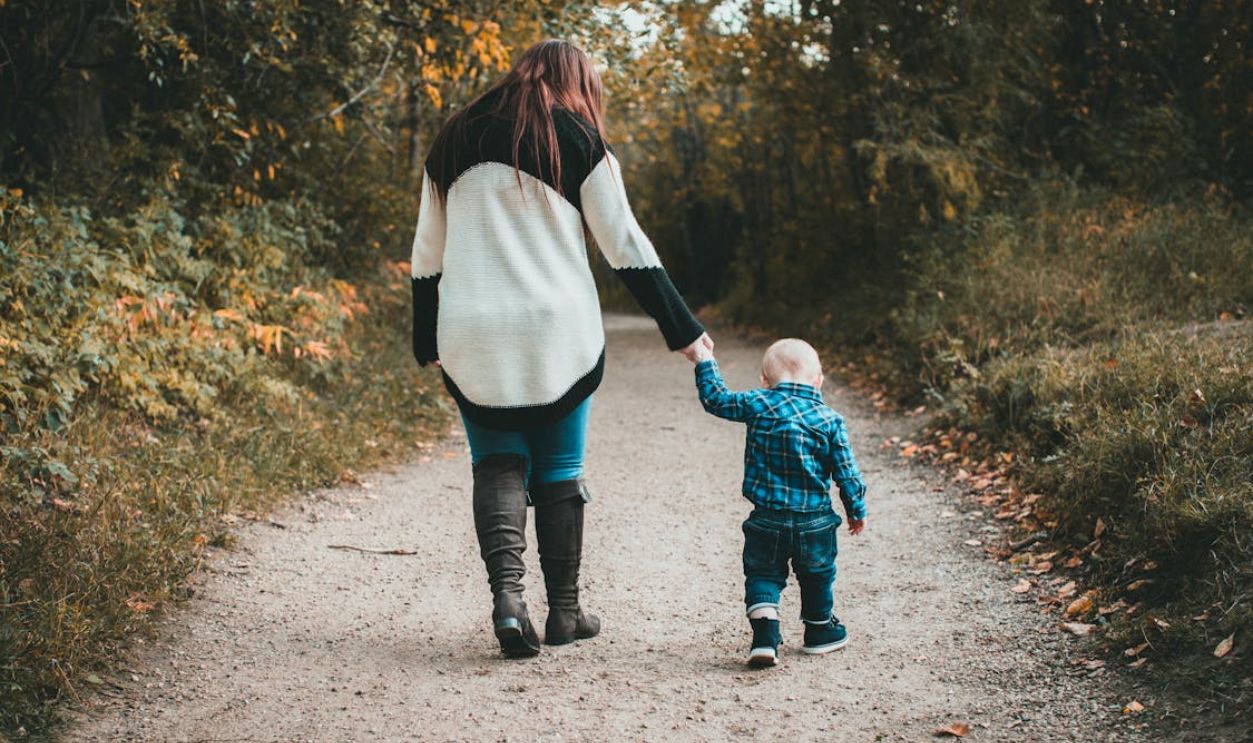 Mother walking with baby son