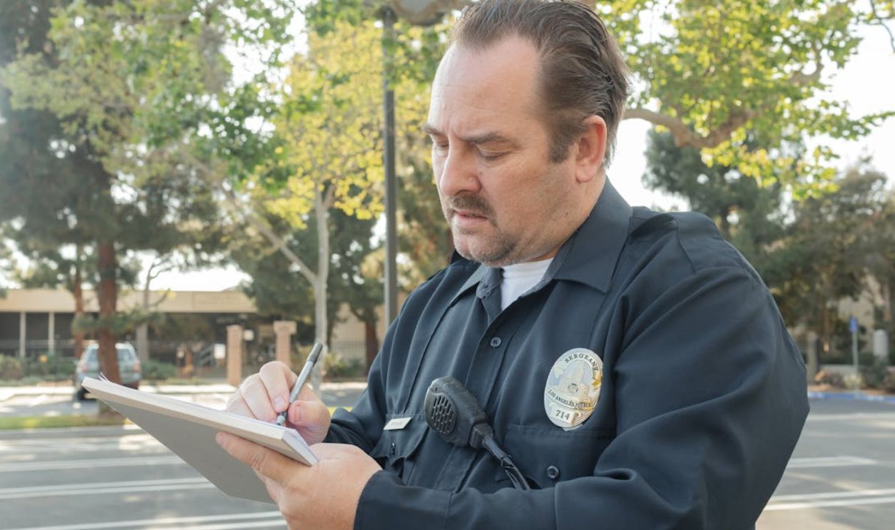 A Police Writing on a Paper
