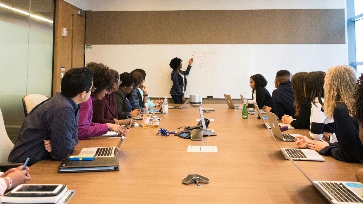 Business meeting with diverse team discussing projects in a modern conference room.