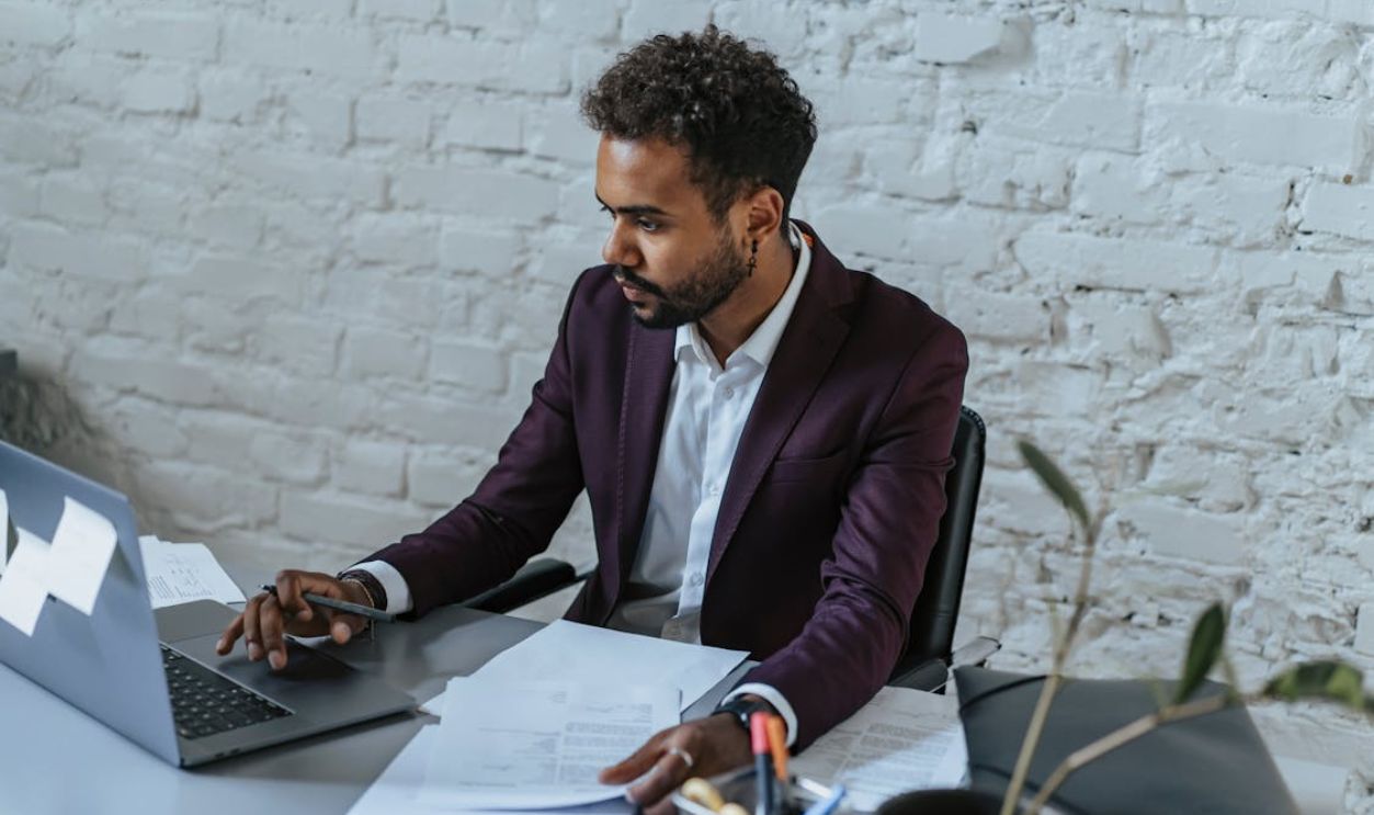 A Man Using a Laptop in Office