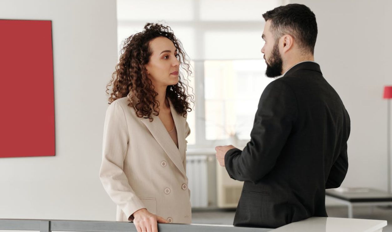 Man and Woman Talking in Office