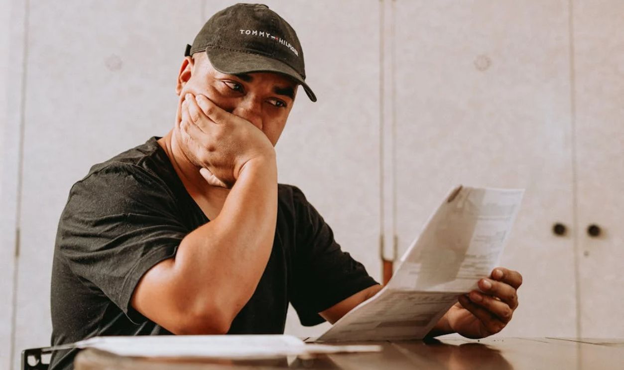 Reading letter looking worried