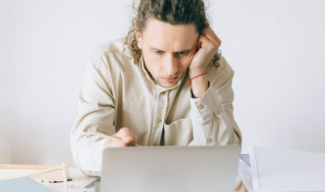 Woman in Beige Coat Using Silver Macbook