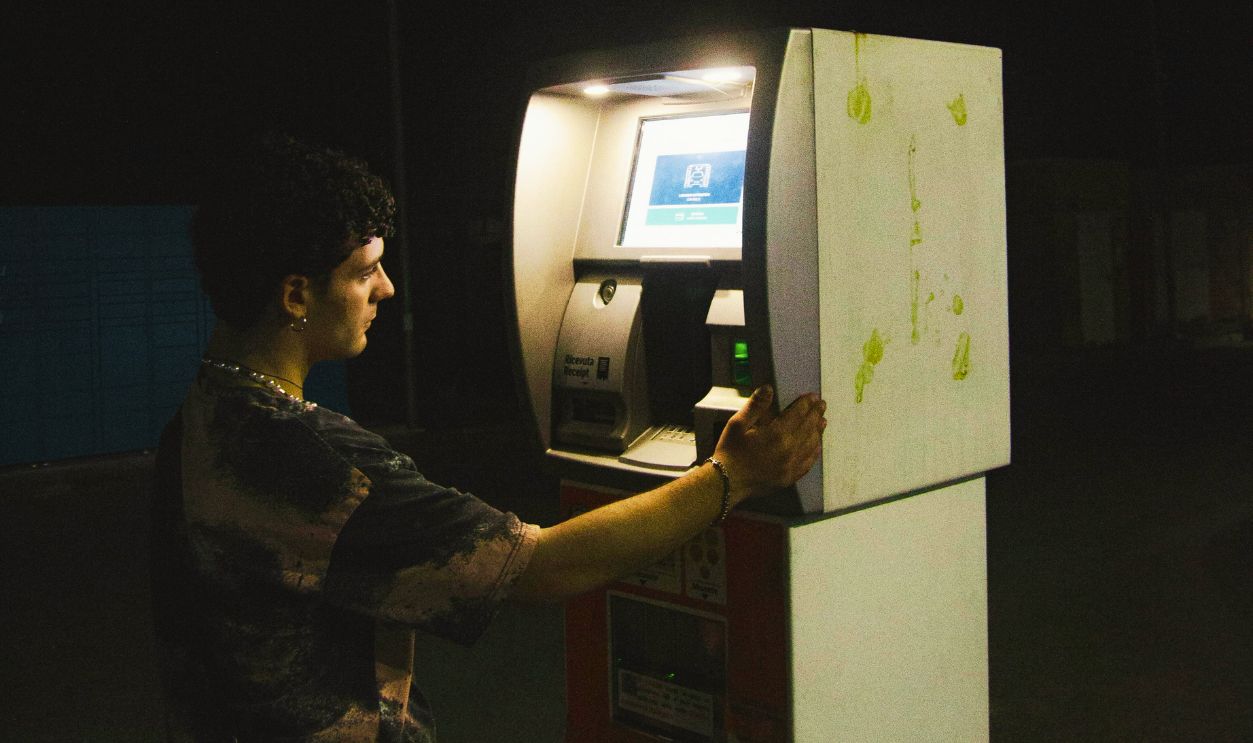 Man near ATM Machine at Night Street