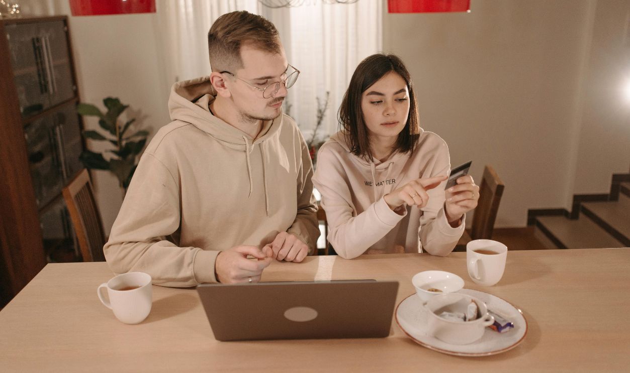 couple using laptop with credit card