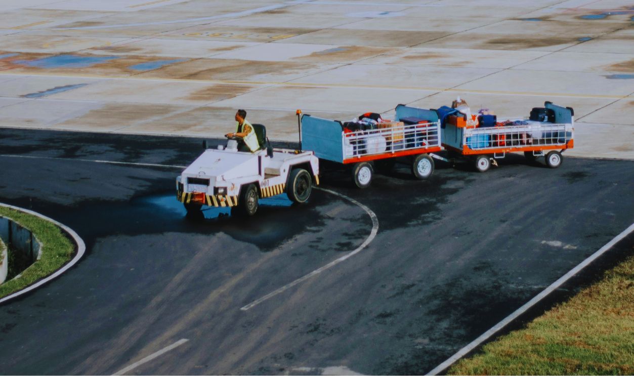 Man Riding on Vehicle With Trailers